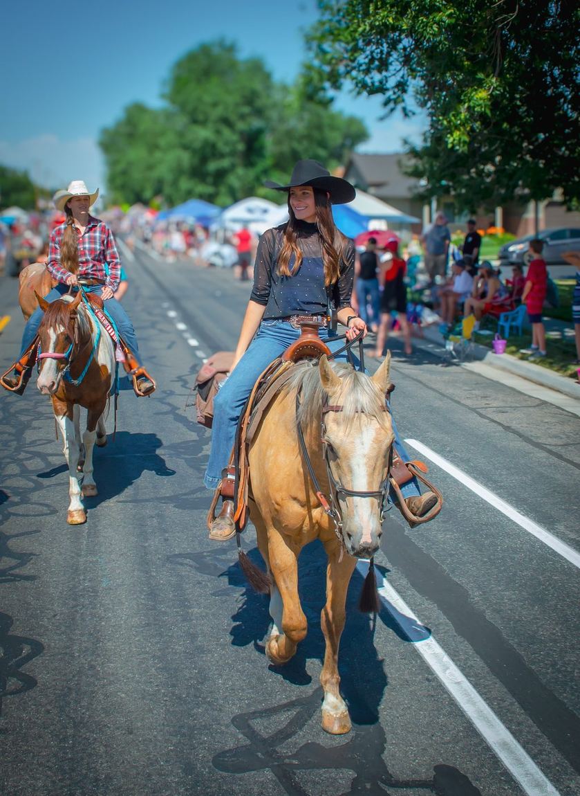 Jennifer riding a palomino in a local parade.
